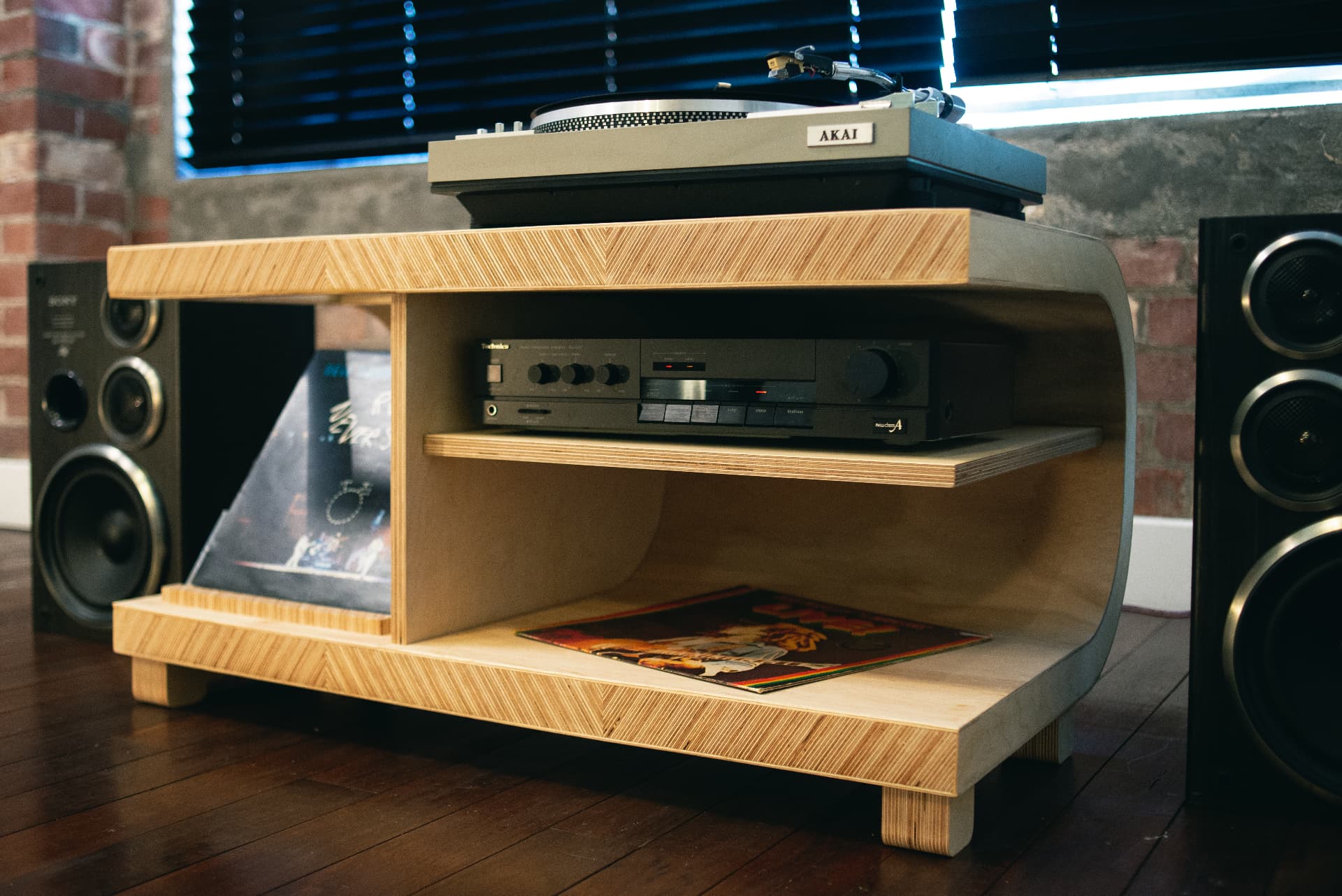 33⅓ cabinet in a London flat, holding an Akai turntable and Technics amplifier between two speakers