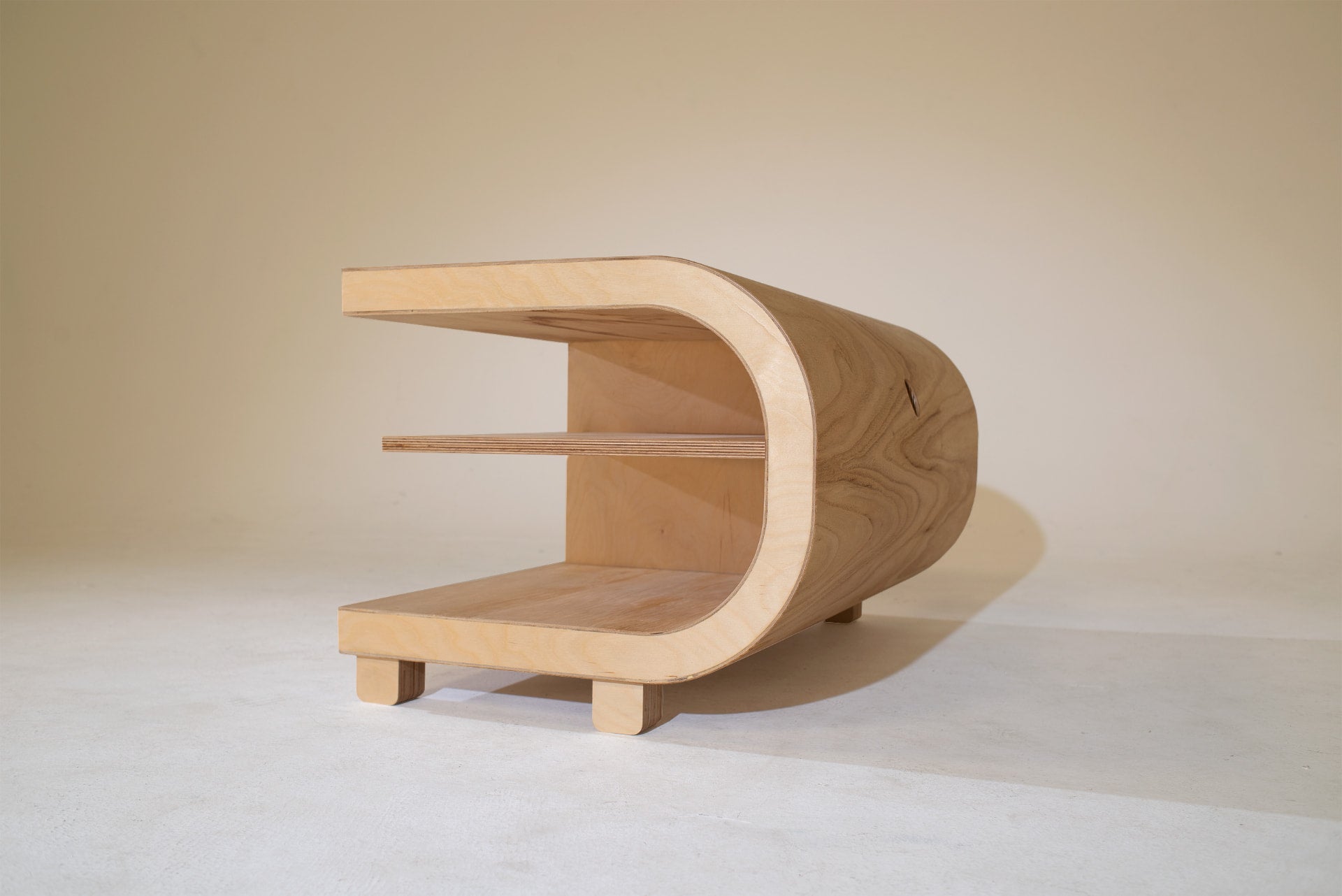 Three-quarter view of the 33⅓ cabinet showing the continuous curved plywood shell